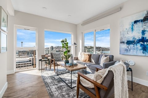 an open living room with a view of the city and a couch and chairs  at Oslo, Seattle, Washington